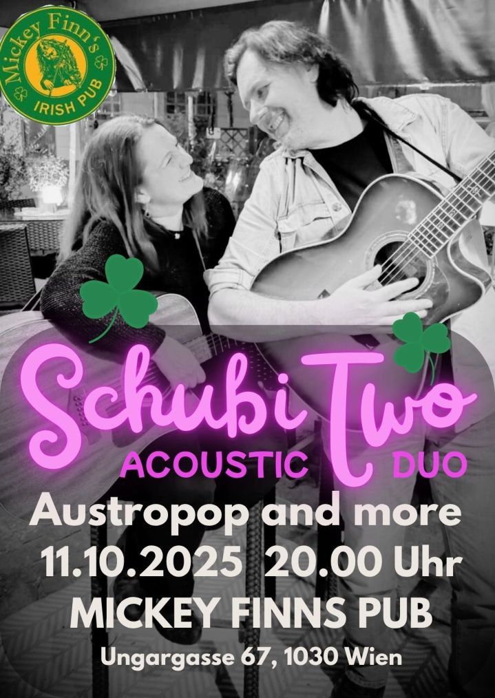 Small club stage: acoustic duo mid-performance with colored lights and audience silhouettes.