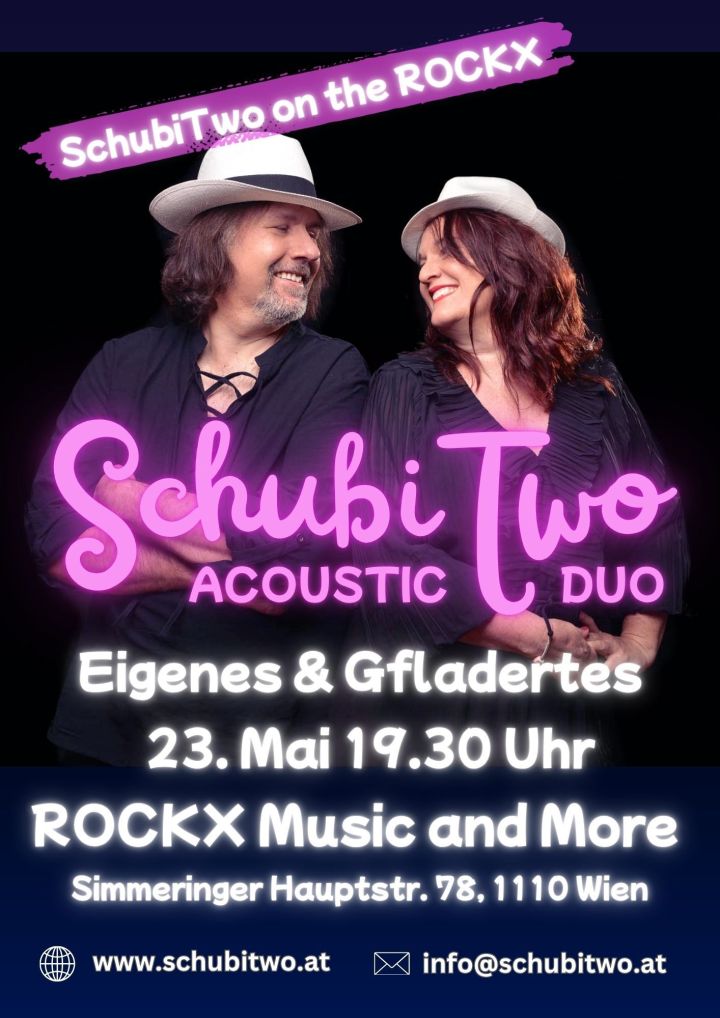 Small club stage: acoustic duo mid-performance with colored lights and audience silhouettes.